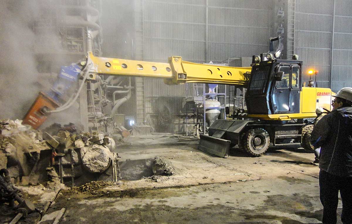 Gradall XL wheeled steel mill maintenance machine breaking refractory with a hydraulic hammer