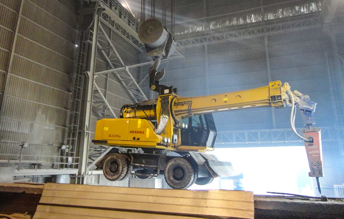 Gradall XL wheeled steel mill maintenance machine positioned on timbers