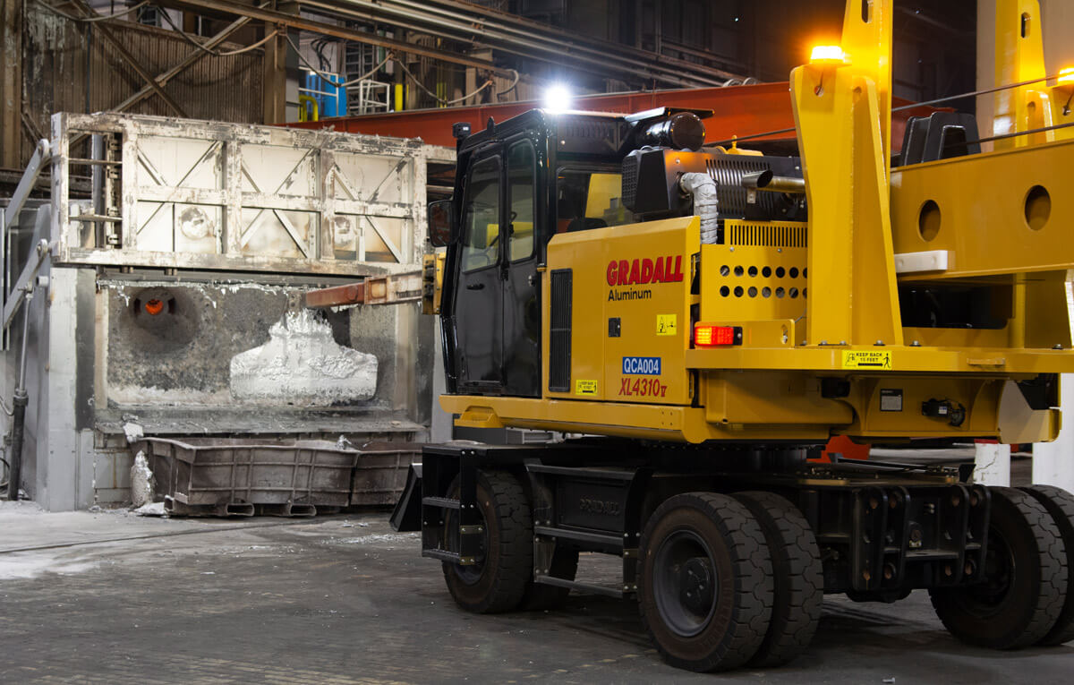 Gradall XL 4340 V wheeled aluminum mill maintenance machine working at a furnace